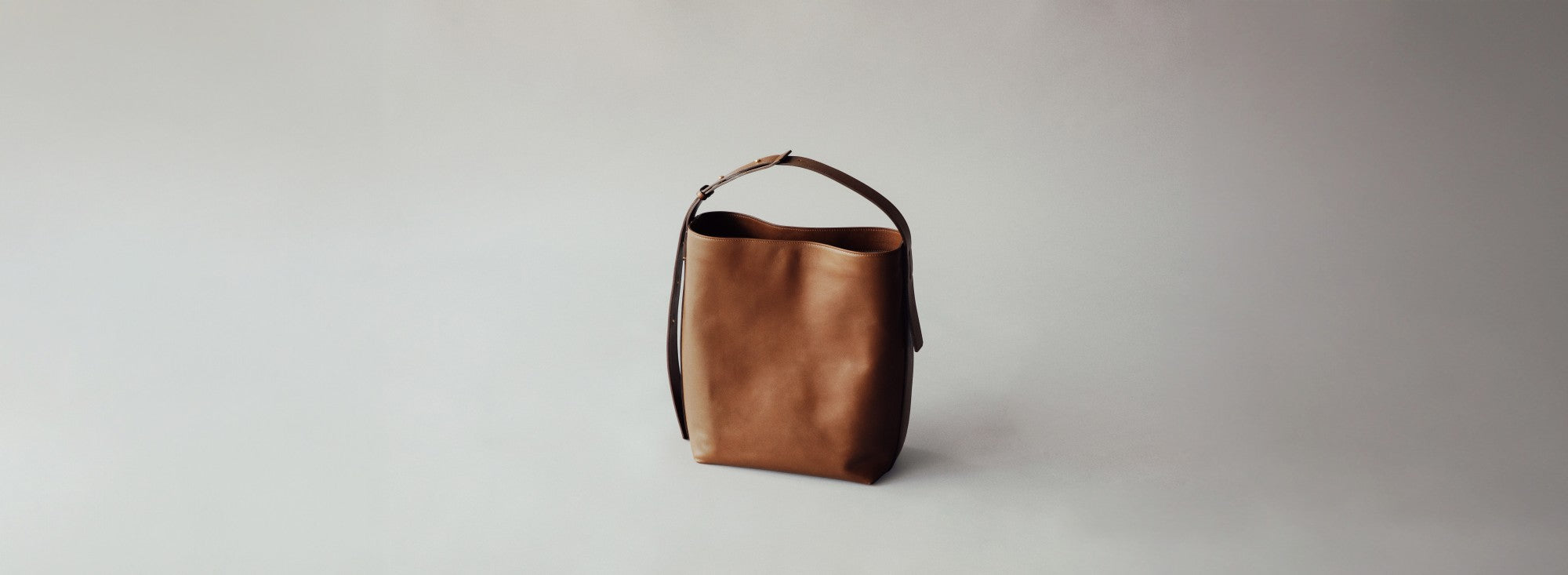 Atlow series black leather tote and brown handle bags