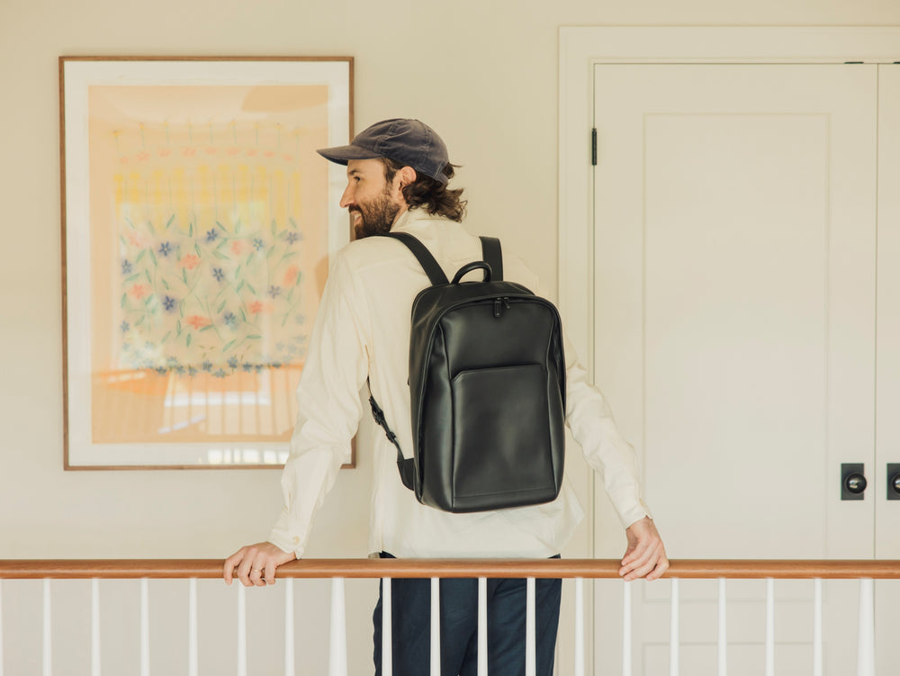 Smiling man wearing a backpack