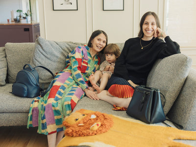 Mother and daughters sitting on a sofa