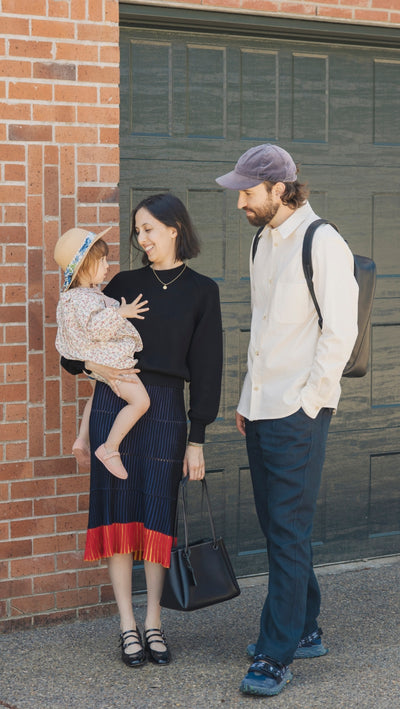 Father and mother looking at their daughter