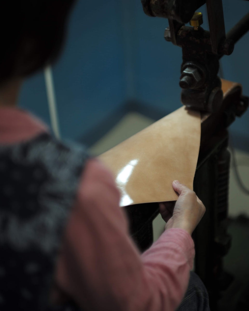 Person operating a machine with a focus on their hand and the equipment.